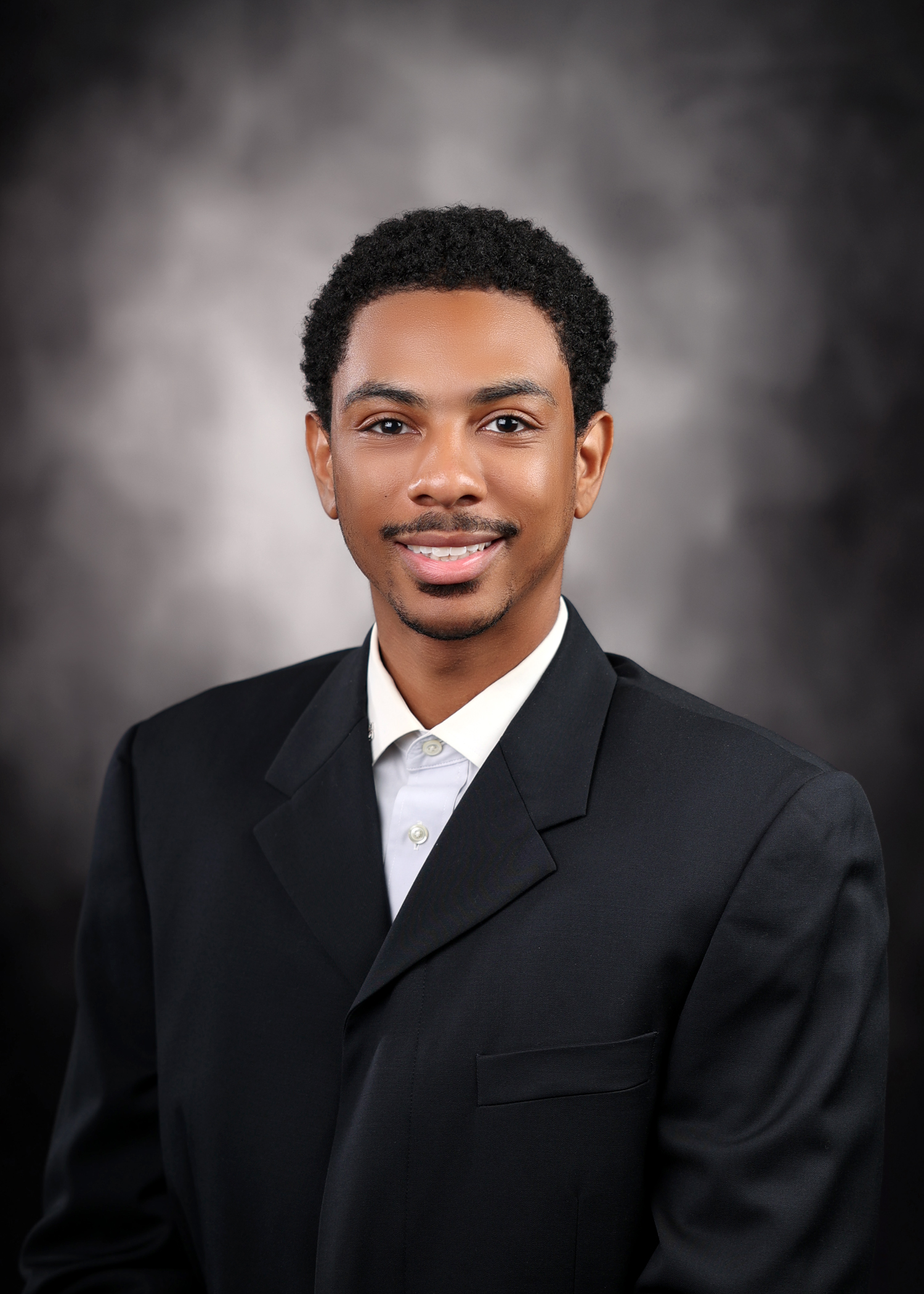 Professional headshot of Renald Powell Jr.
